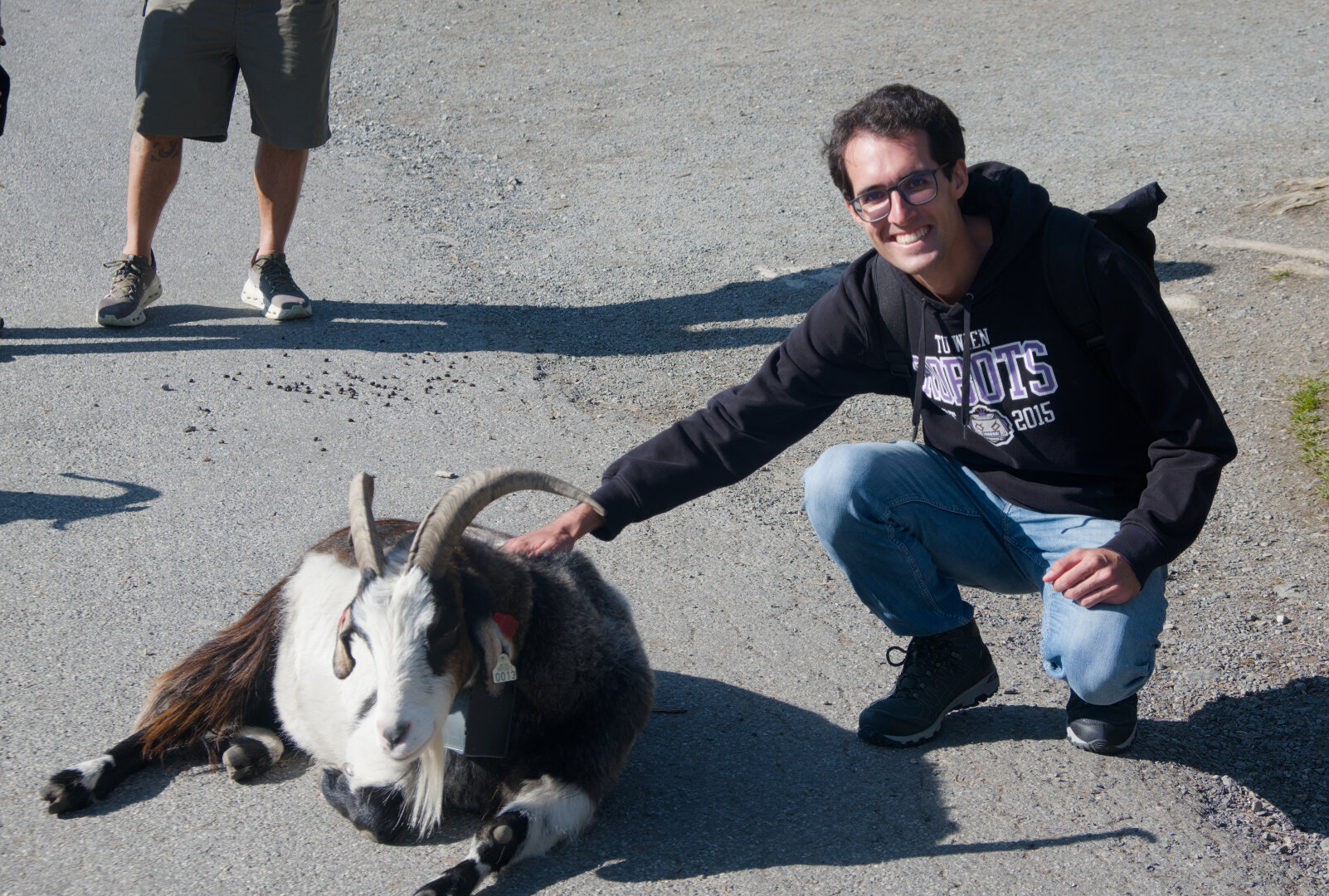 @daniebeler on the right petting a goat