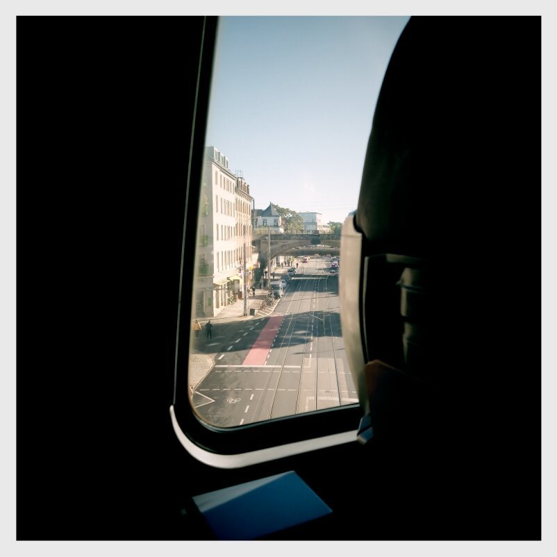 Street scene seen from a train window.