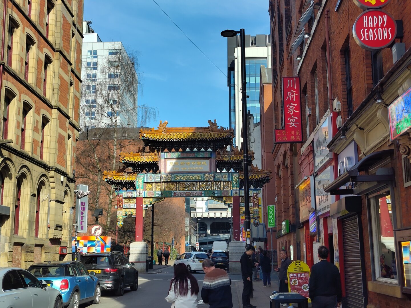 Chinatown Arch, and Chinese shops and people walking on the street