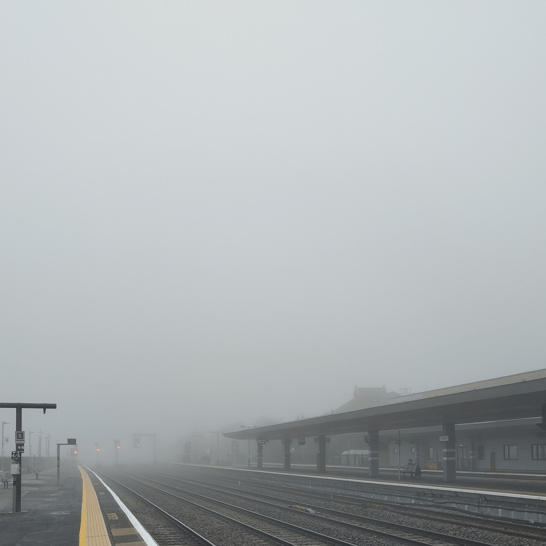 A very foggy day. Picture from train station showing railways that disappear dissolved in the mist not very far away