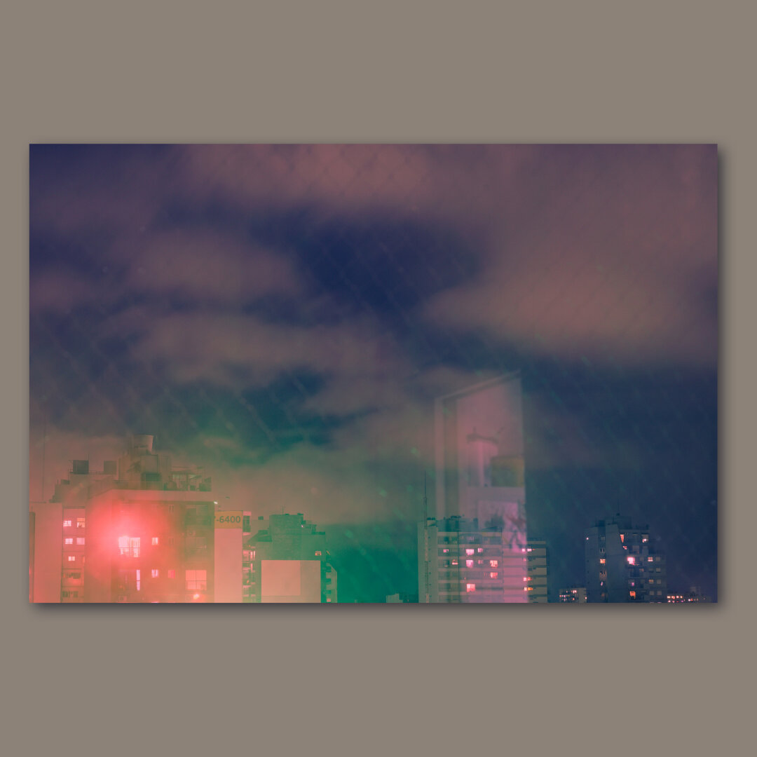 A night view through a window with some partial reflection.