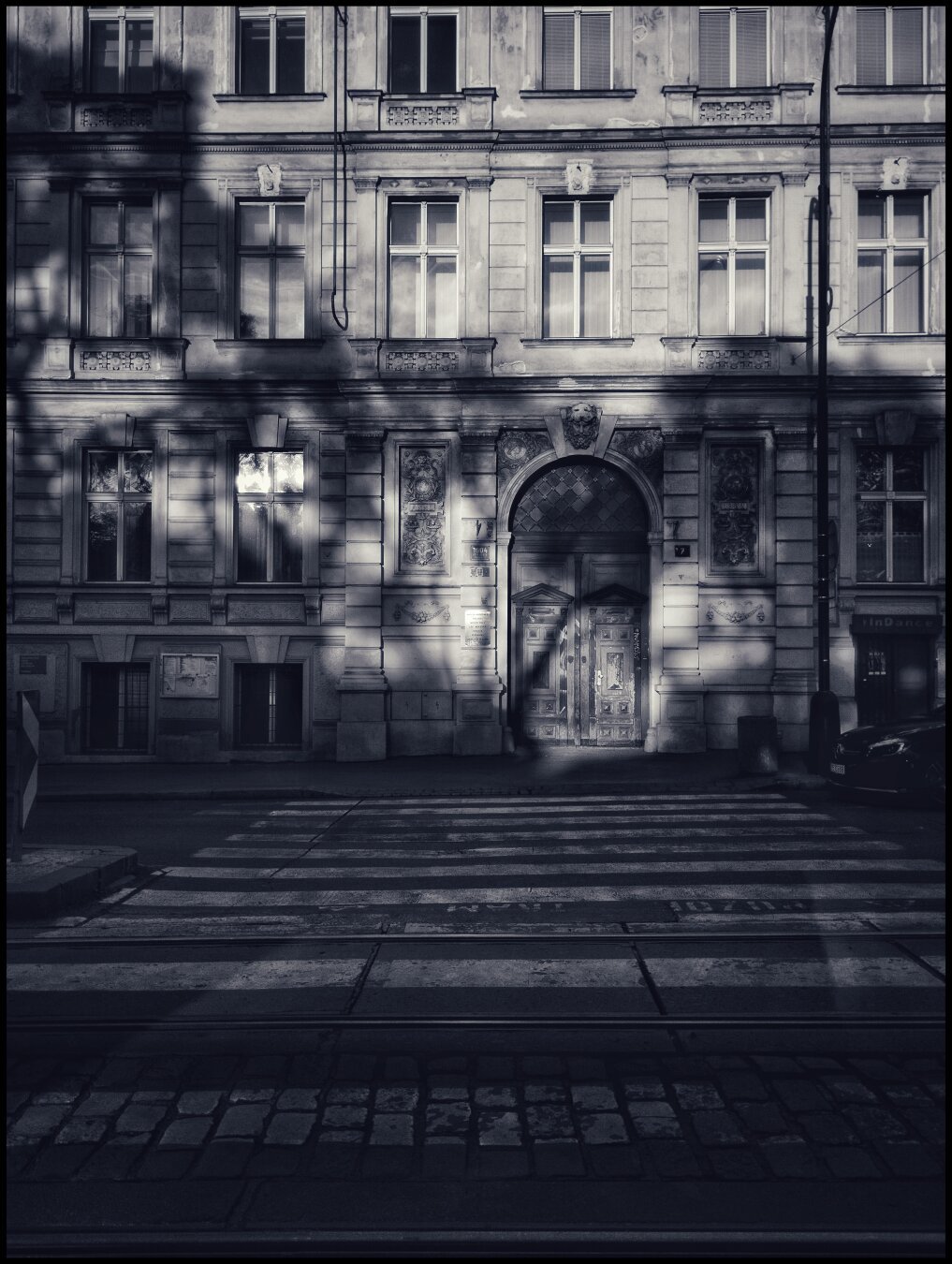 Just some random monochrome image of a building in a Prague with the shadows of trees cast upon the building... Not really a good shot, your not missing anything... It's just a boiler plate I guess