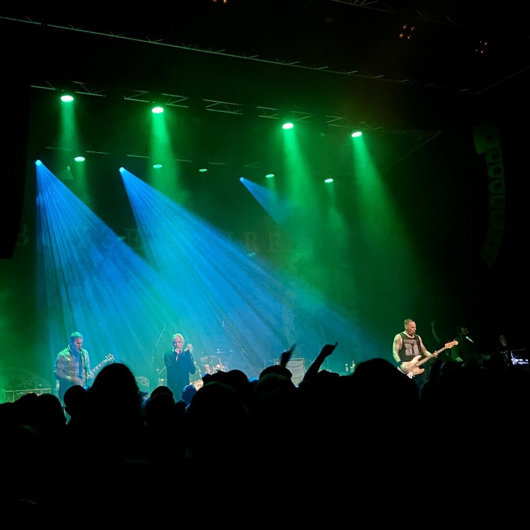 The band BoySetsFire on stage at Tollhaus Karlsruhe on October 4th, 2024. Green and blue lights setting the stage.