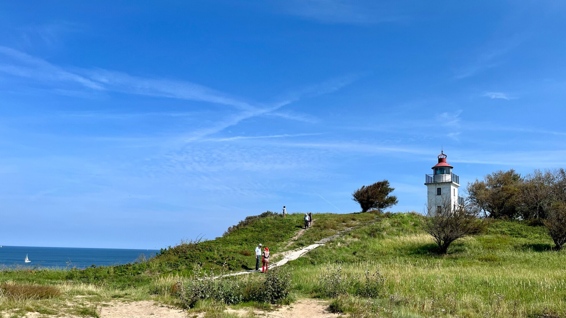 Lighthouse called «Spodsbjerg Fyr» at the Hesselø Bugt under a bright blue sky