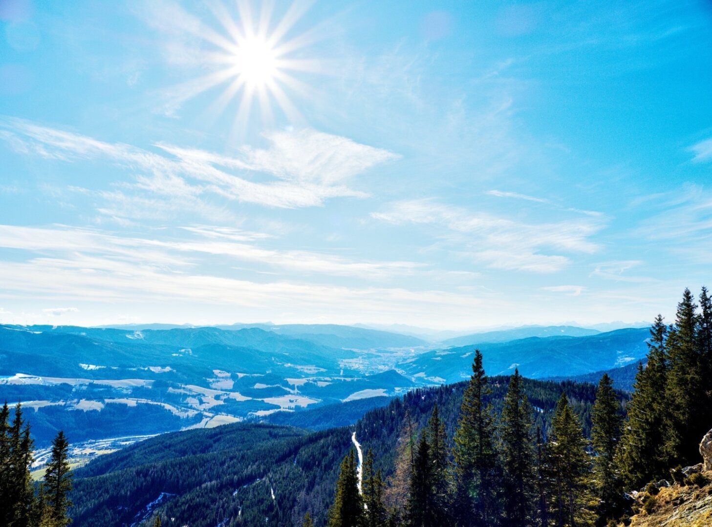 Alpine landscape in early spring with sunstar