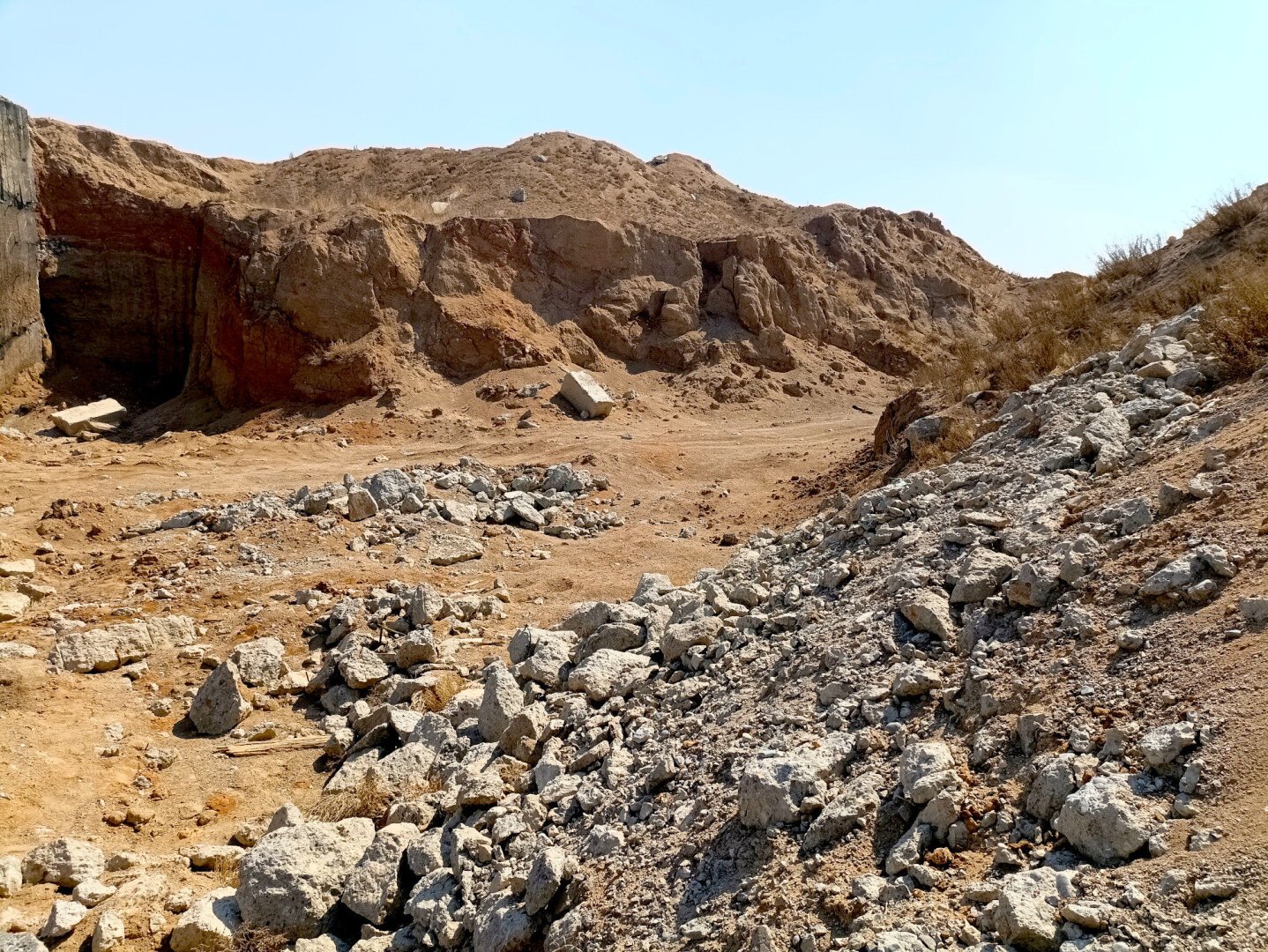 Huge mounds of earth, scattered with rubble conceal the entrance to an old nuclear bunker
