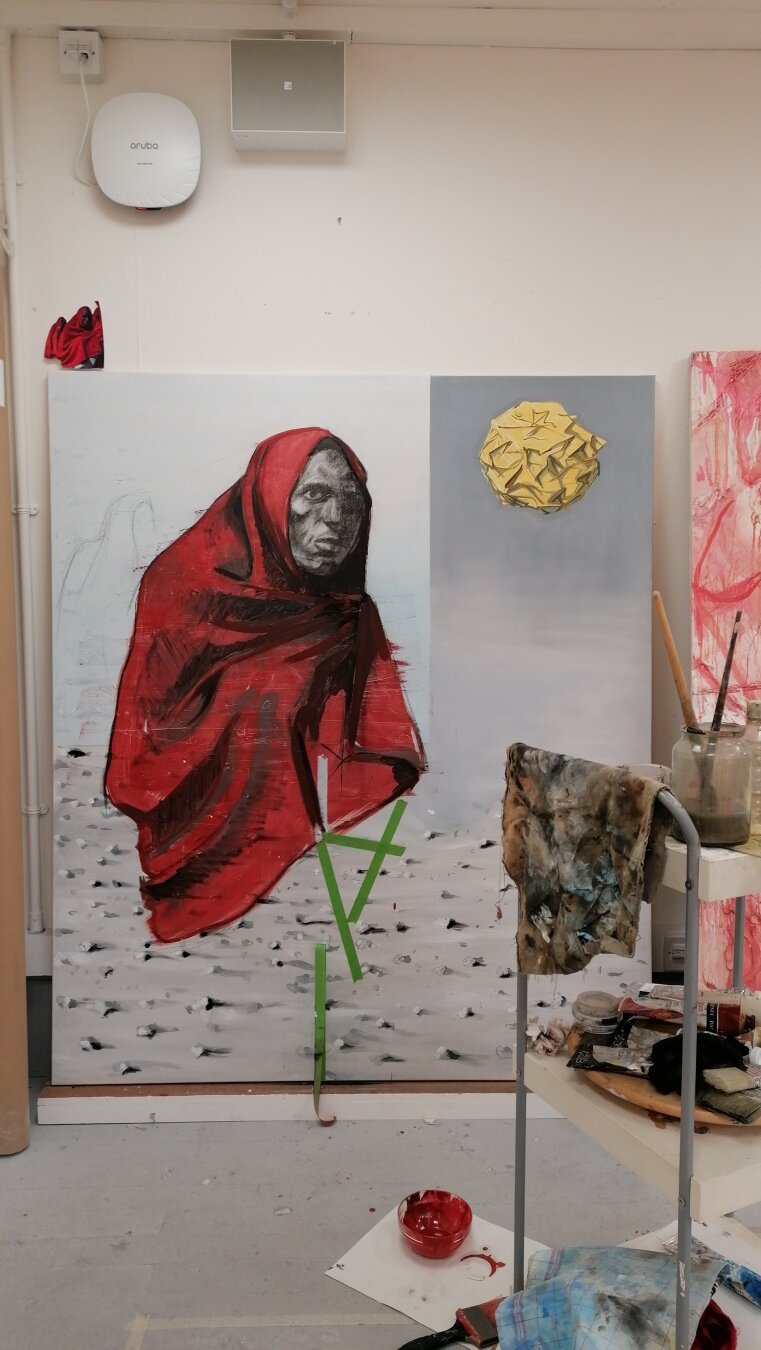 Image of a person covered with a red blanket painted in a canvas