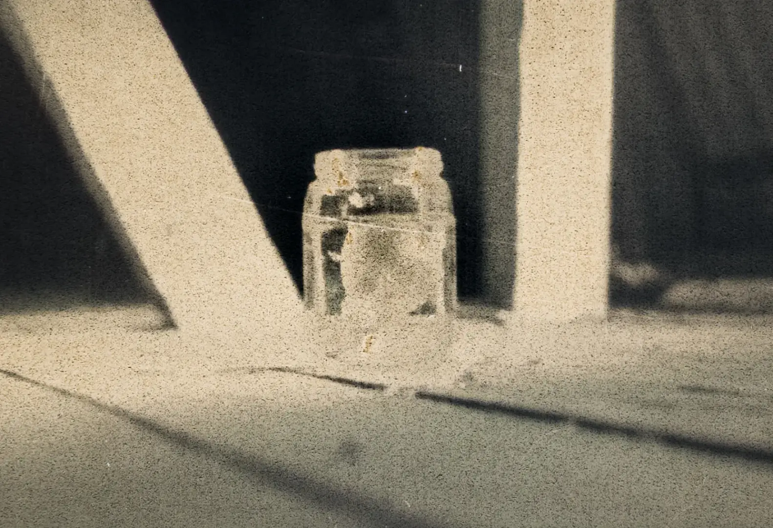 A light bulb in a jar sitting on a wooden floor