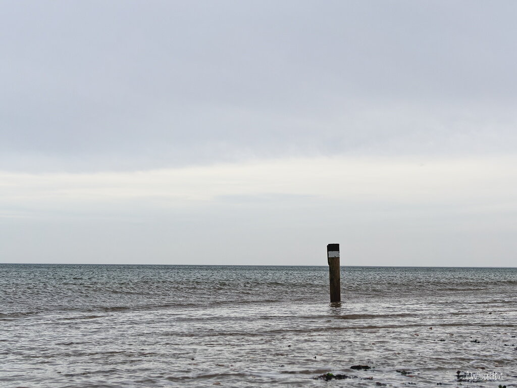 Post on the foreshore at high tide