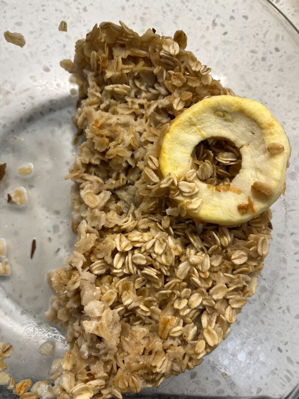 Half a bowl of oatmeal with one side looking like an eye.
