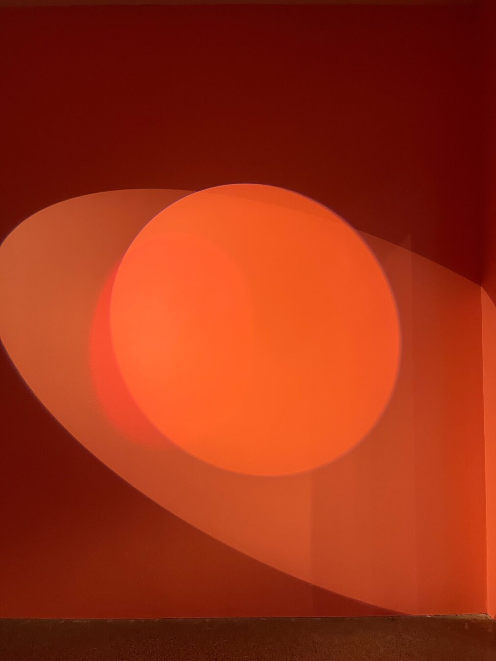 Two spotlight par lights with shadows on a wall.