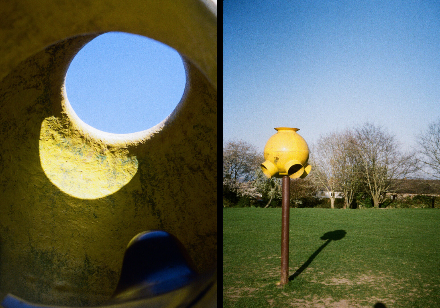 A diptych made of two photographs placed side by side on a black background. On the left, a close-up view from inside a yellow, textured structure shows a large circular opening at the top, revealing a bright blue sky. Sunlight enters through the opening, casting a curved, glowing patch of light on the inner surface. The scene feels abstract, with rough surfaces and warm yellow tones contrasting with the cool sky. On the right, the same yellow object is seen from the outside in a grassy park. It stands on a metal pole and has several rounded openings, resembling a small sculptural lamp or playground feature. Behind it are leafless trees and a clear blue sky. The object casts a long shadow across the grass. Together, the two images show the same subject from inside and outside
