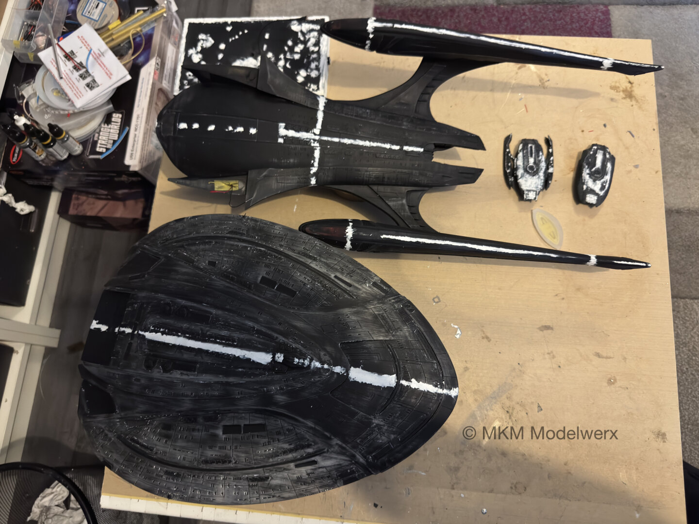 Model parts sanded with some black primer remaining and white putty along the joints.