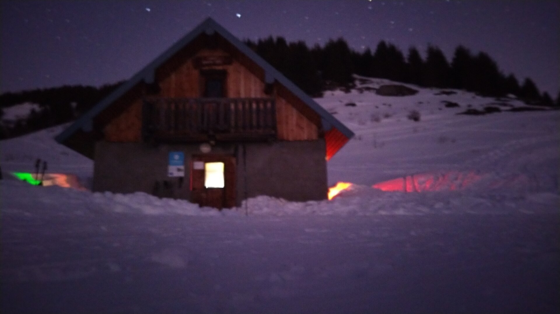 Unguarded shelter by night in a snowy environment.