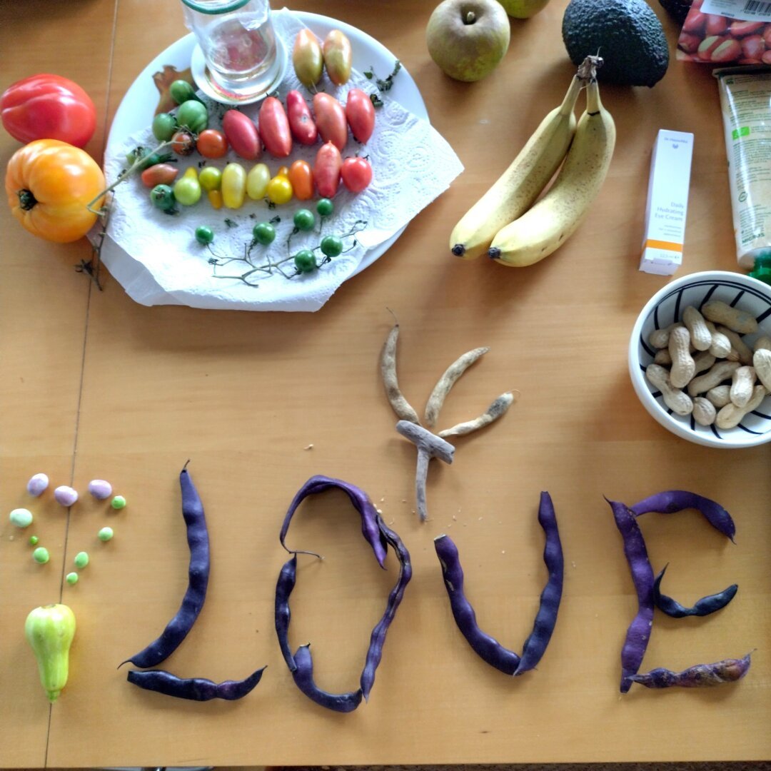 an image from my Pixelfed (because, fuck instagram), shows a table with various fruits and vegetables, someone spelled LOVE using blue string beans
