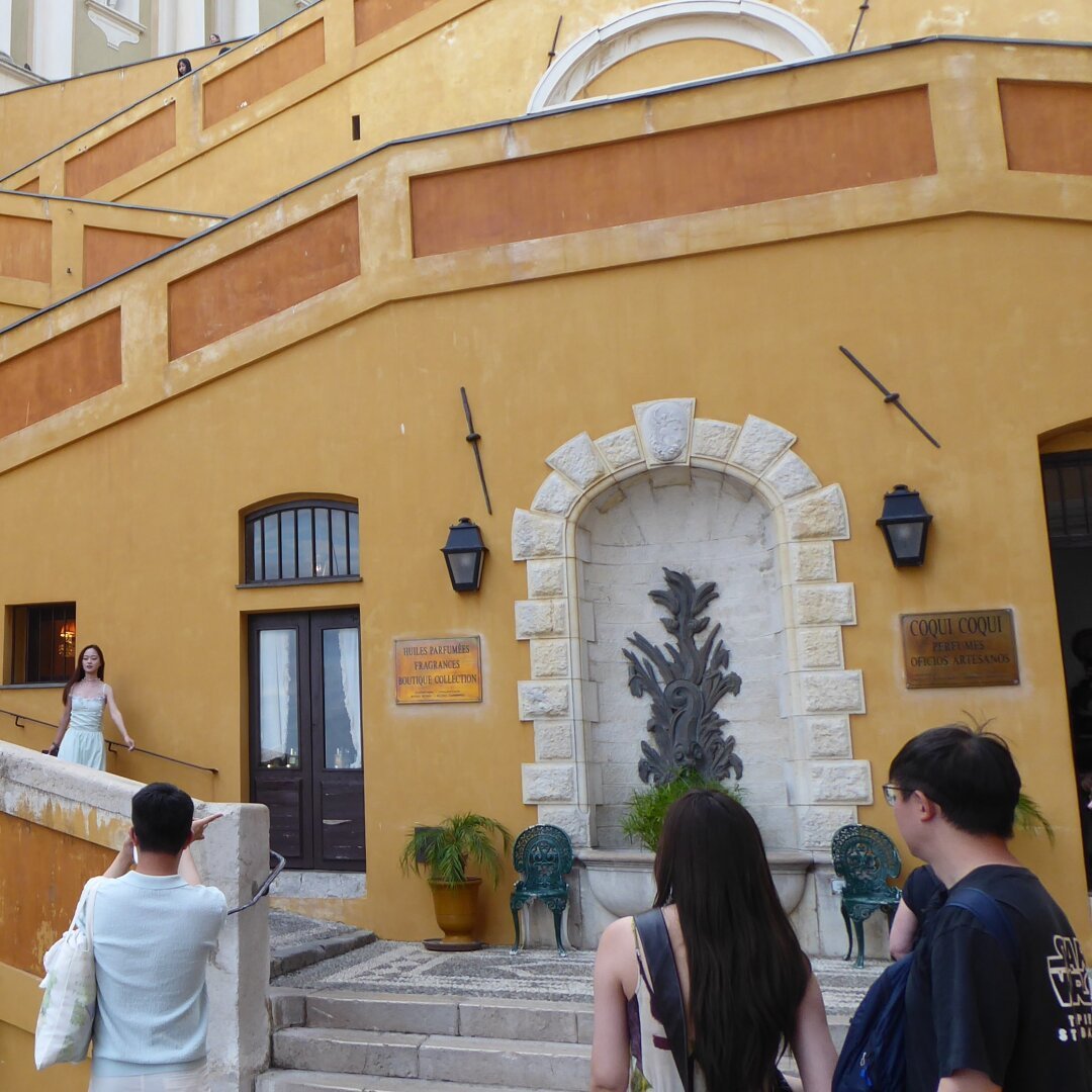 an image from my Pixelfed (because, fuck instagram), shows people posing for photos on picturesque stairs in yellowish colors