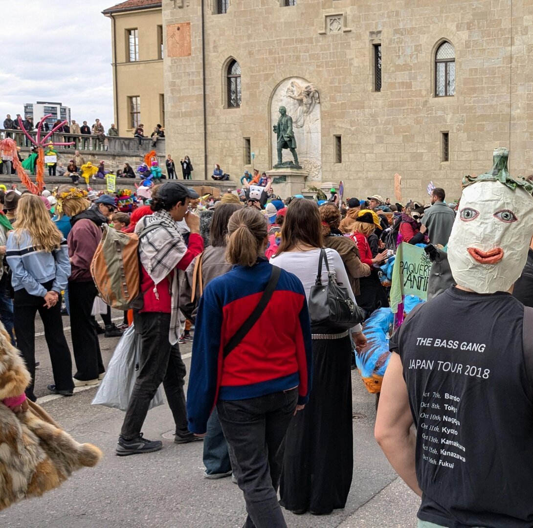 The revelers assemble on the place du chateau in Lausanne near the Major Davel statue. Masks and costumes everywhere