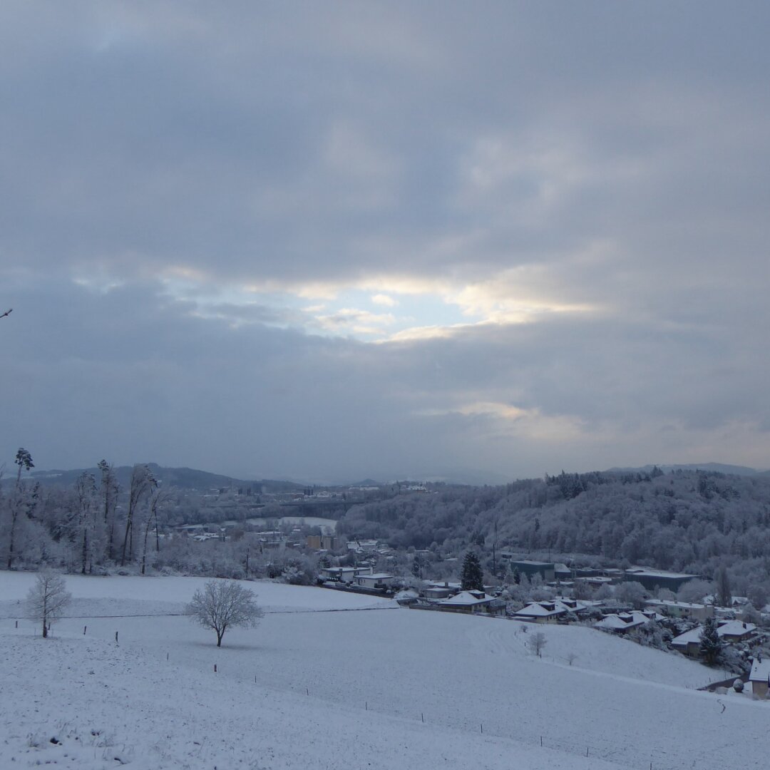 an image from my Pixelfed (because, fuck instagram), shows a valley with some snow, the sky is ripped open allowing some light through