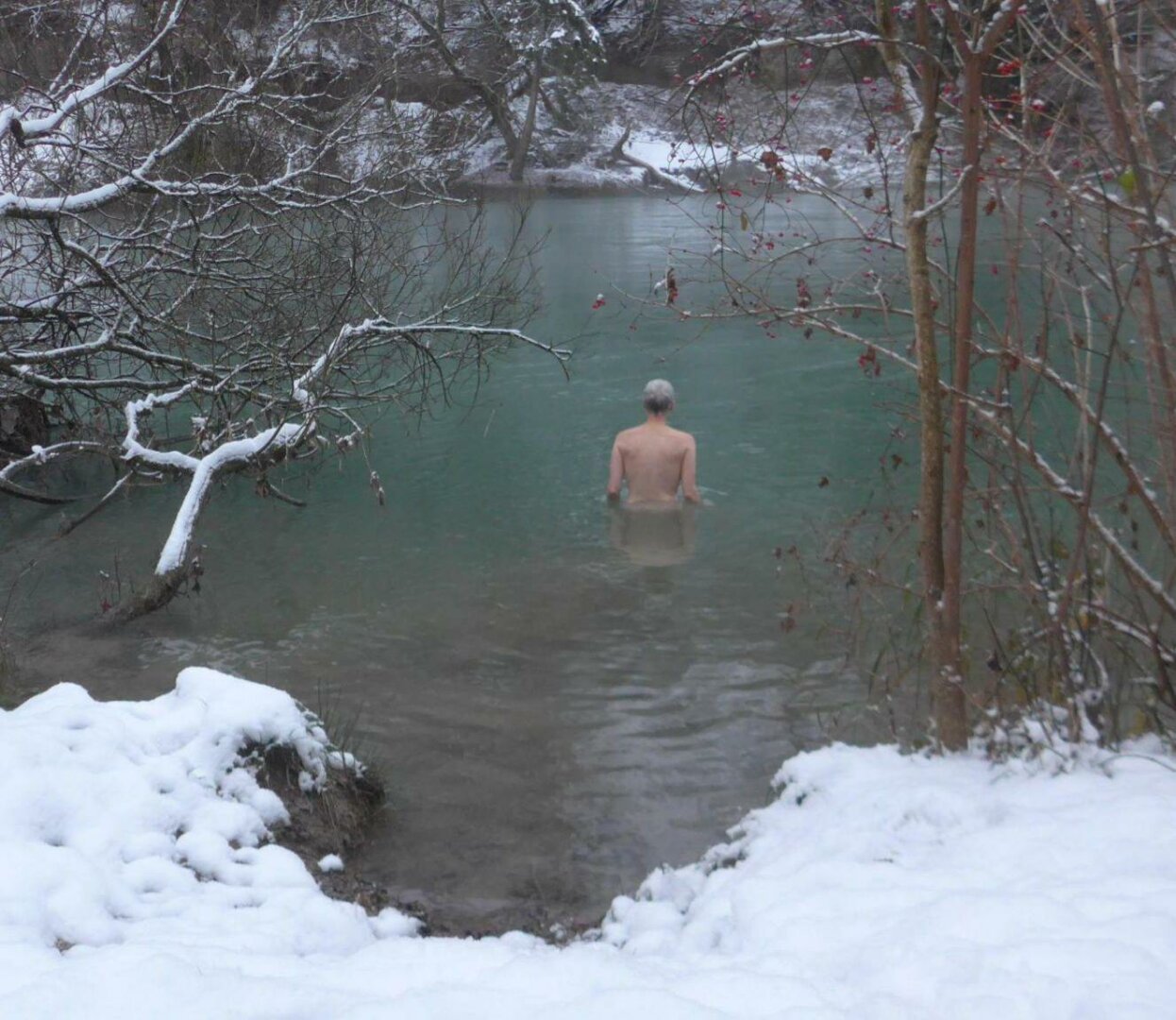 an image or two from my Pixelfed, shows a woman taking a dip in a river with snow on the floor