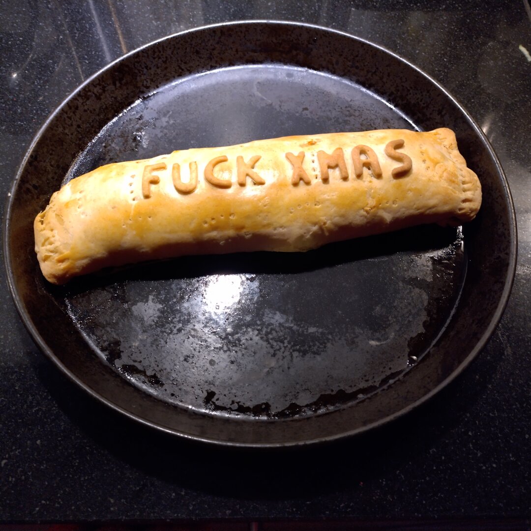 an image from my Pixelfed (because, fuck instagram), shows a baked mushroom wellington, written on top it says FUCK XMAS