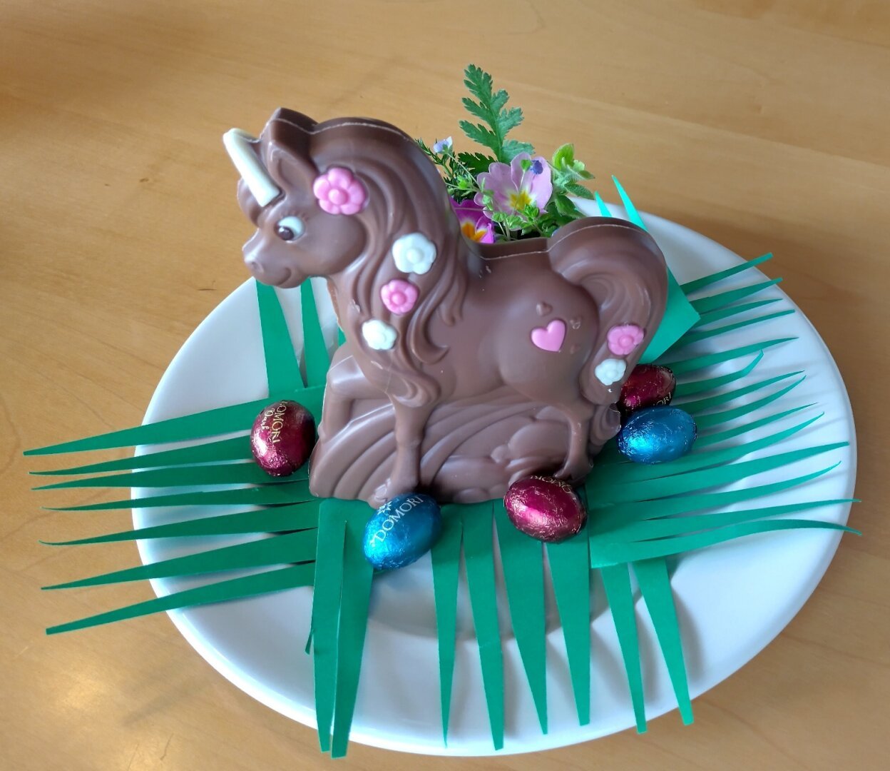 an image or two from my Pixelfed, shows a unicorn made of chocolate surrounded by some easter chocolate eggs