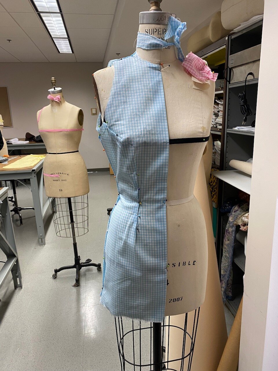 A draping of a sheath dress on a mannequin.