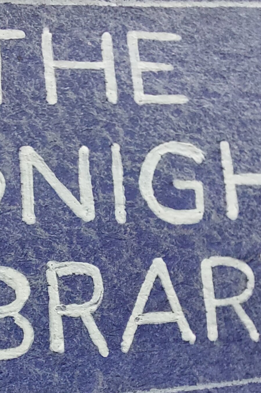 Closeup of blue label with parts of white font visible