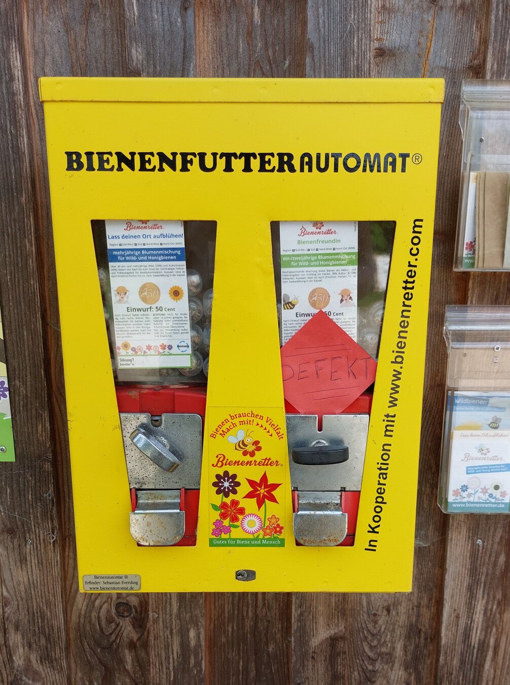 Bright yellow gumball machine but dispensing flower seeds