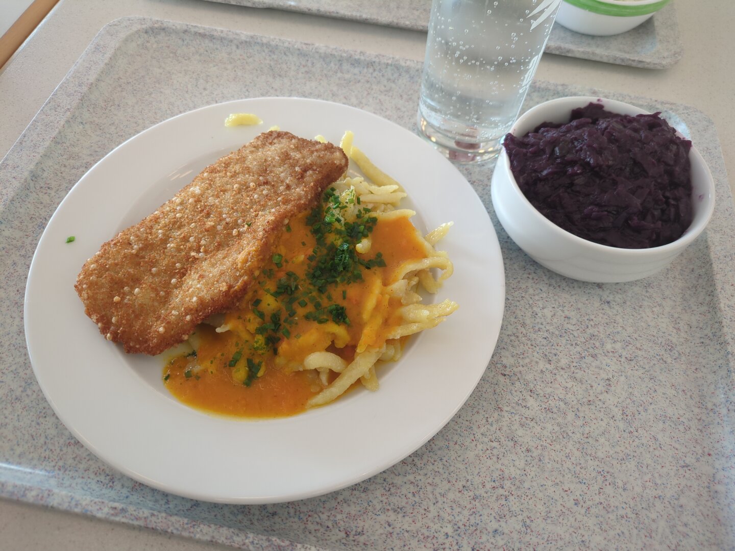 Photograph of the dish mentioned. The red cabbage is placed in a small white bowl, the rest on a large white plate. All items are located on a marble tray.