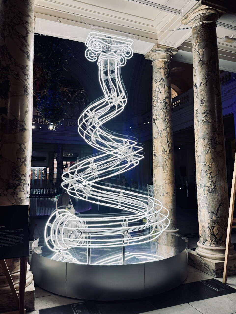 A classic Grecian pillar made out of tubes of light, twisted into the shape of a Christmas tree.