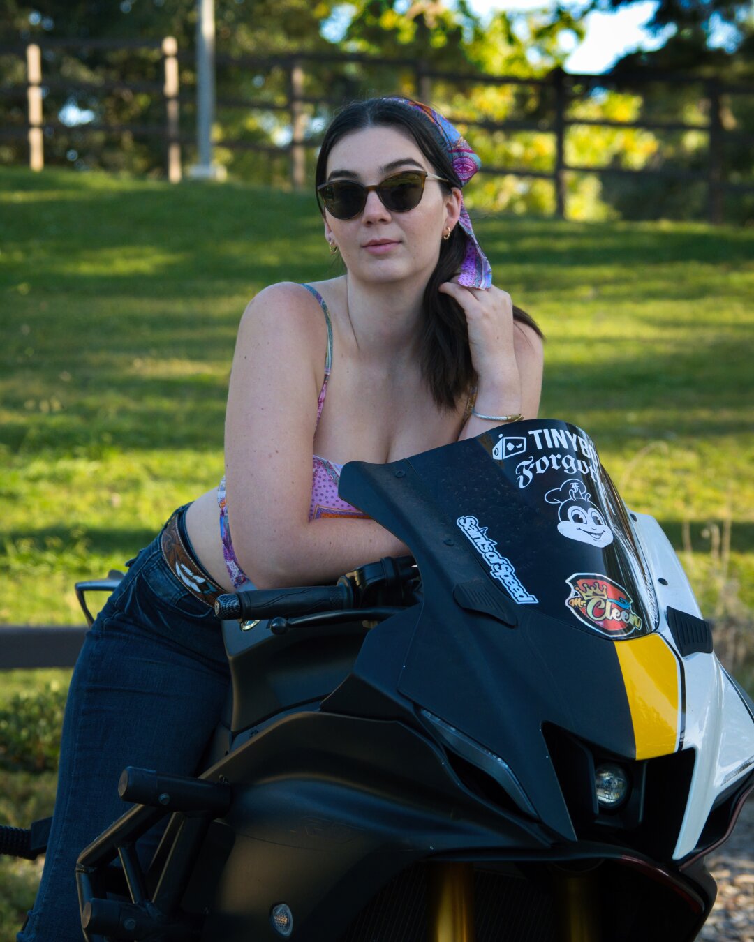 A brunette woman sitting on a motorcycle.