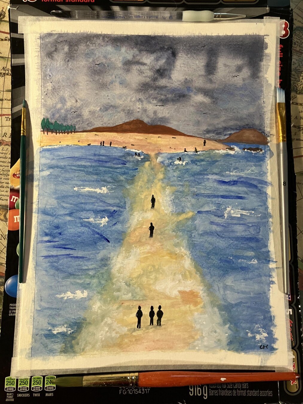 A watercolor seascape featuring a sandstrip leading to a beach. Several standing figures. In the distance, more figures enjoy the water. A few walk on the beach. Mountains and trees can be seen in the distance too.