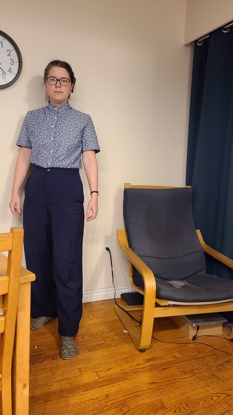 A woman wearing a blue floral chambray shirt