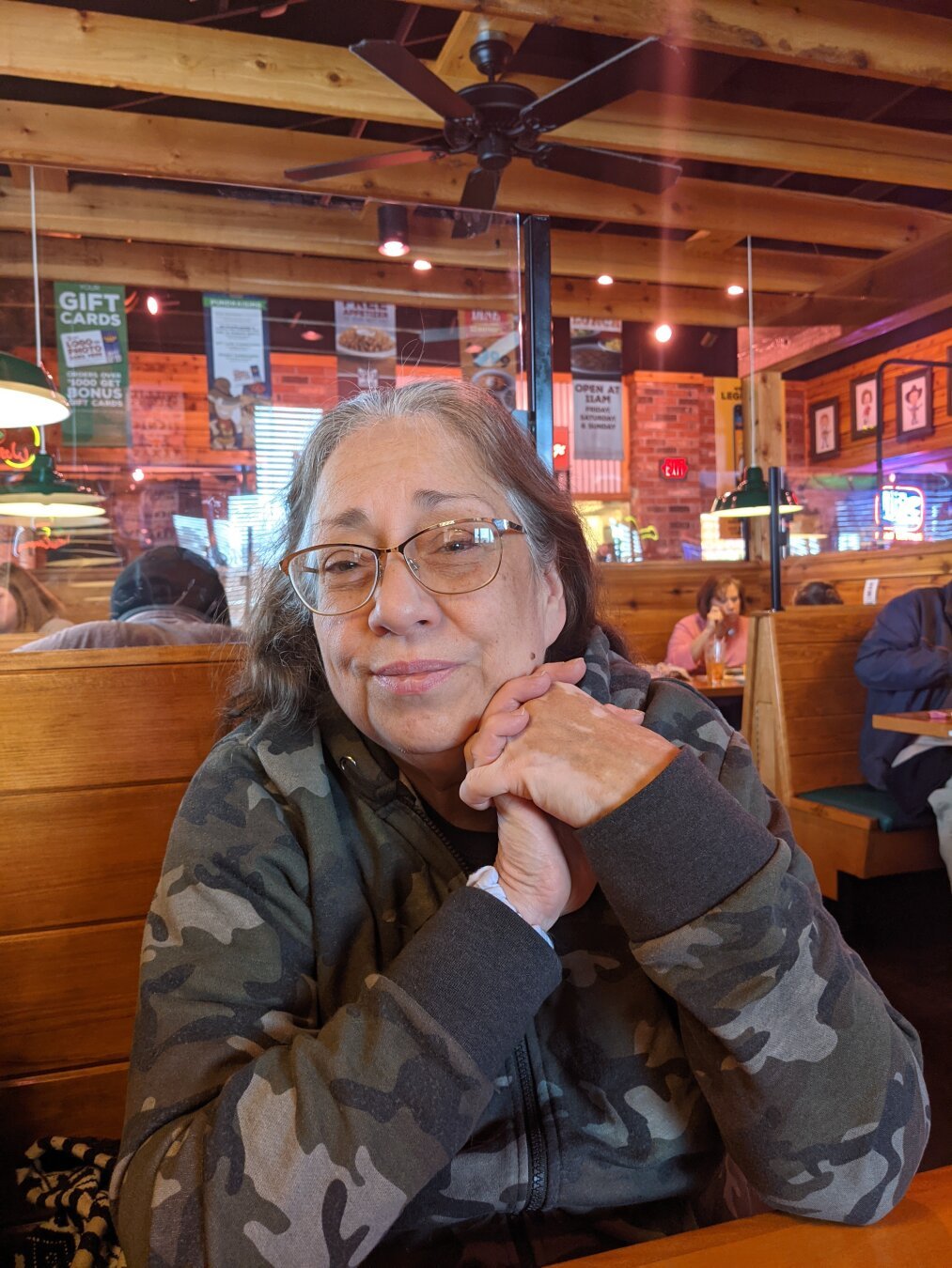 A photo I took of my mother in law sitting inside Texas Roadhouse.