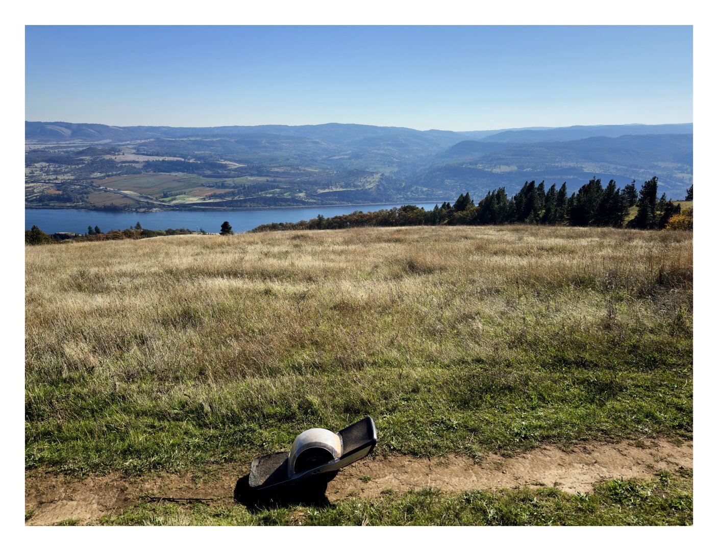 a onewheel in the foreground with the columbia river gorge in the background