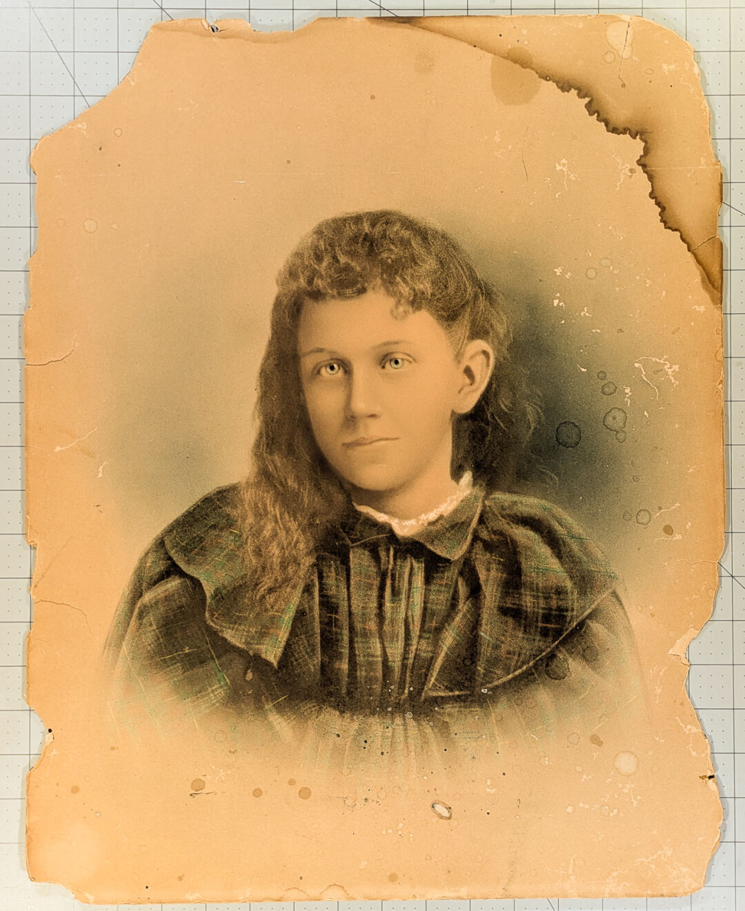 Antique crayon portrait of a young girl in a plaid dress