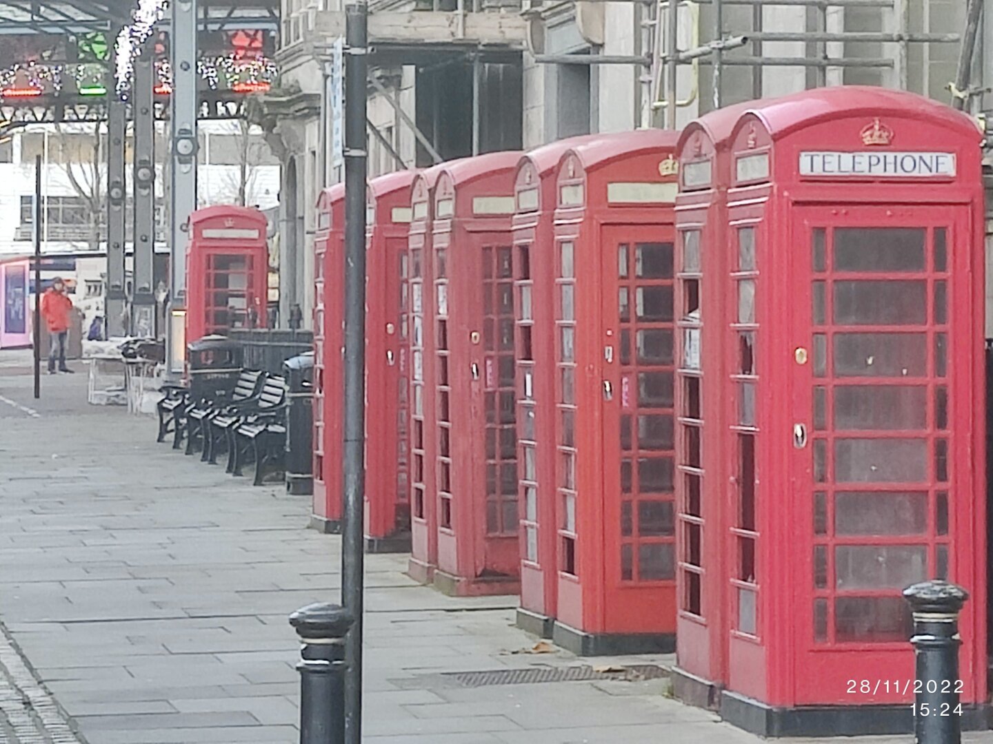 Nine phone boxes, four pairs of boxes close together and ninth box  a short distance away.