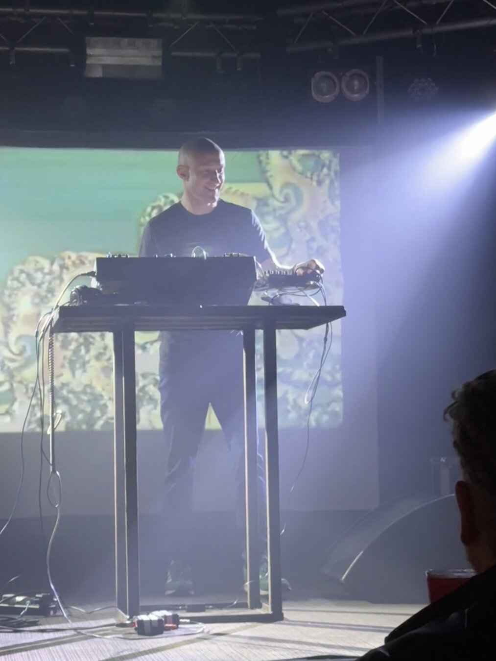 Polypores with modular synth setup in front and video screen behind