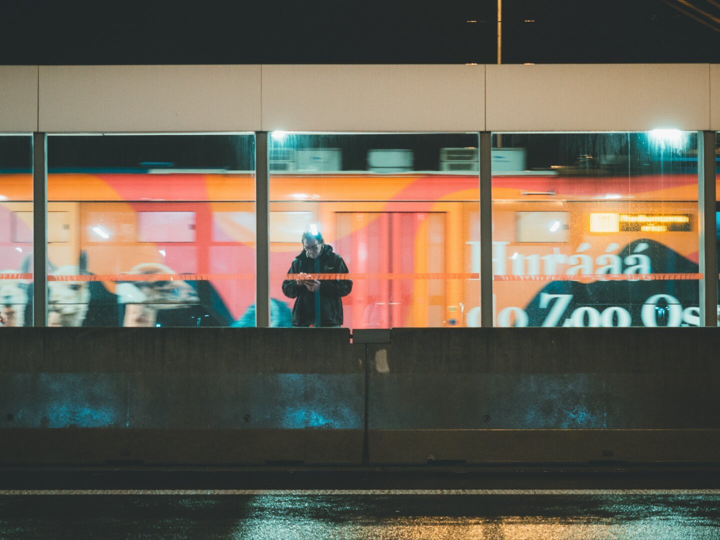 Photograph of people standing on a public transport stop