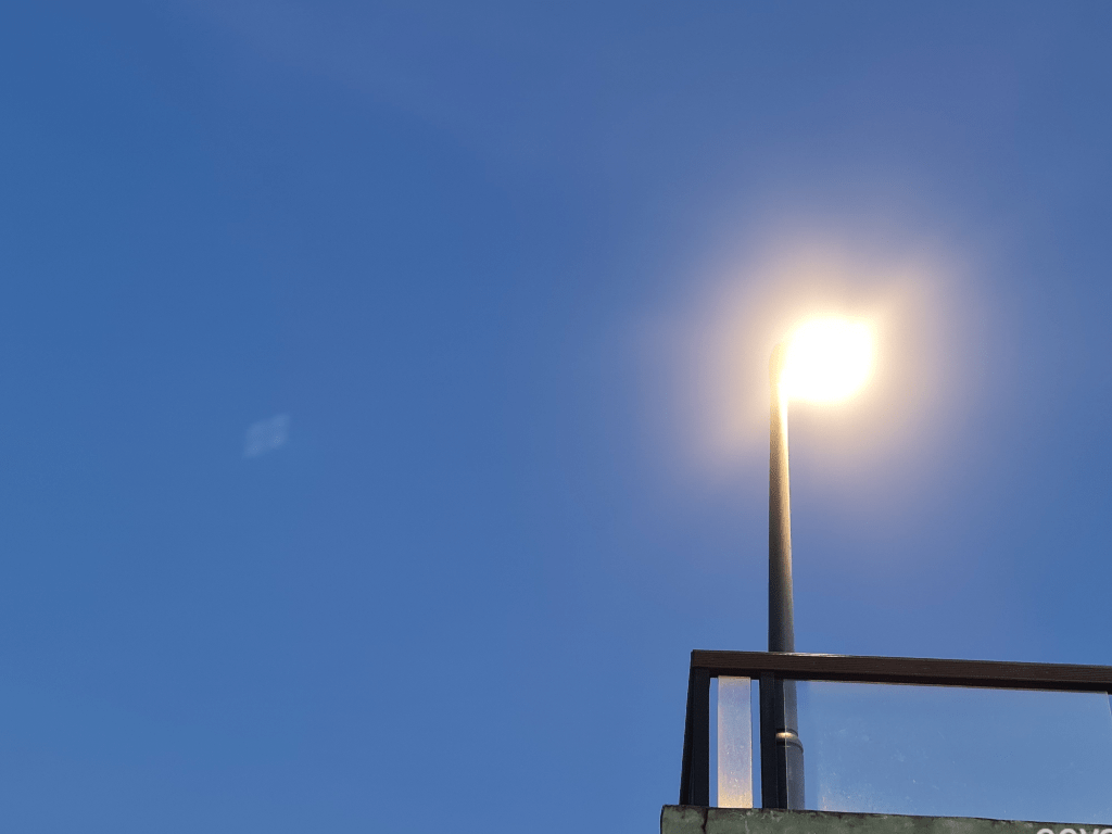 Lampost as seen from below against a blue sky