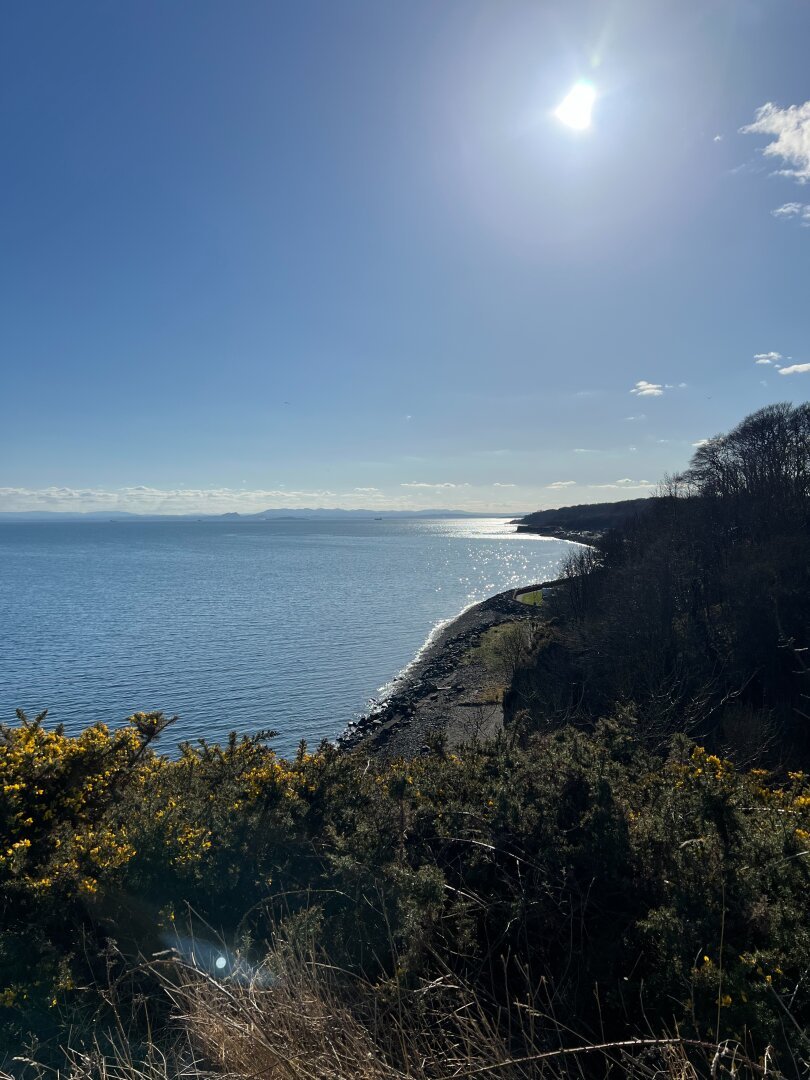 View down from the cliffs onto the coastline and sea.