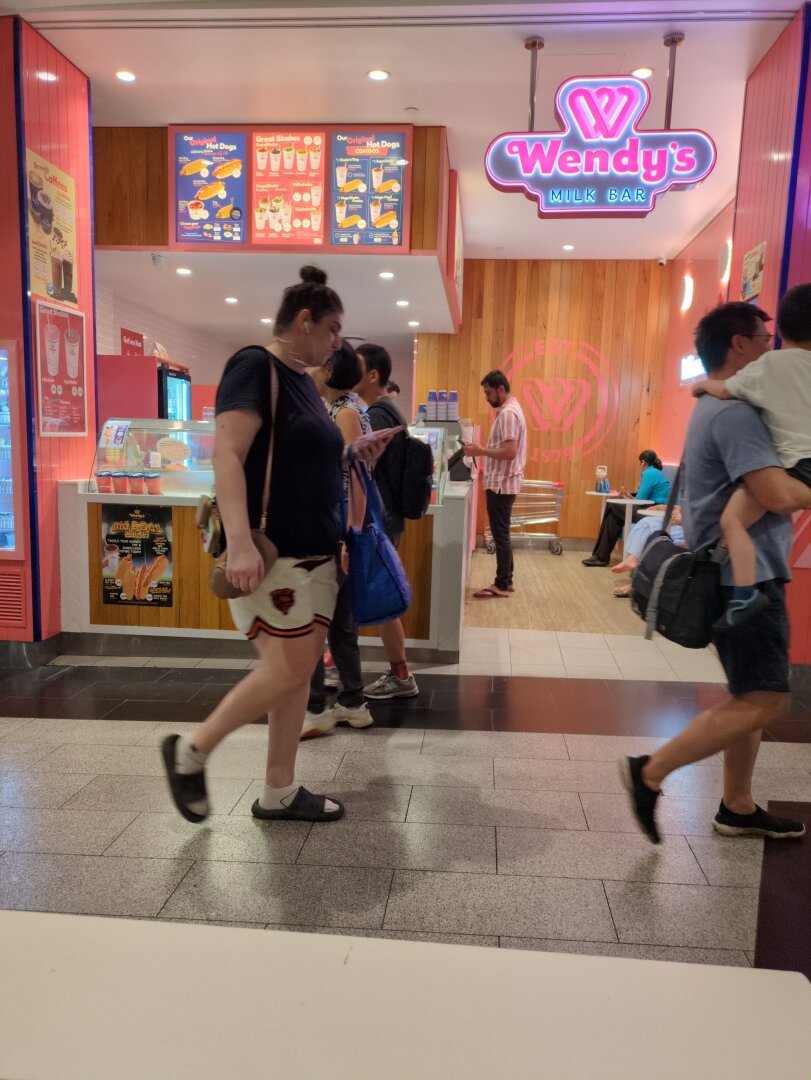 A pink ice cream shop with a sign that reads: Wendy's Milk Bar.