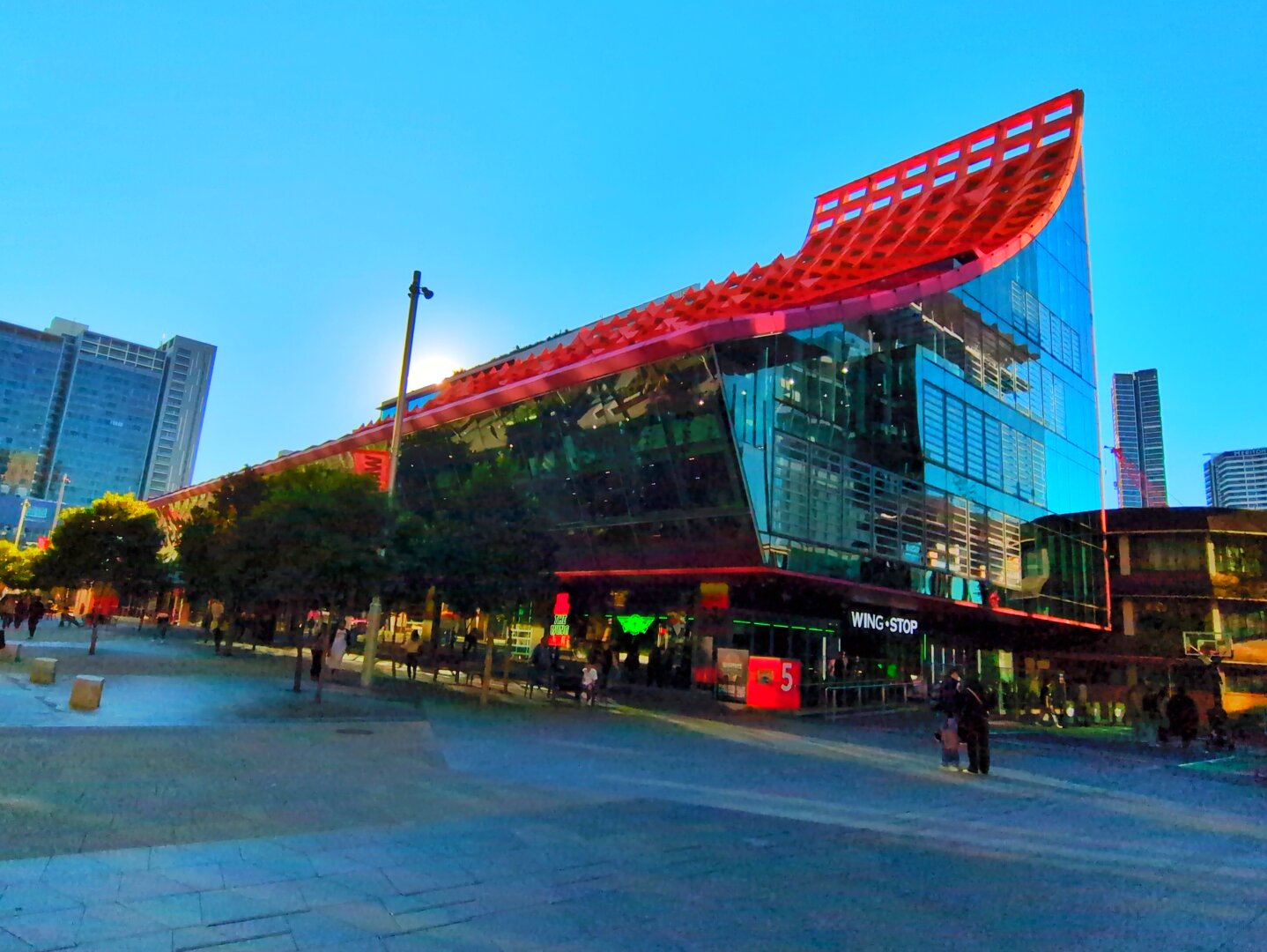 A good view of the Phive Building, with its bright red sloping roof, and teal glass windows.
