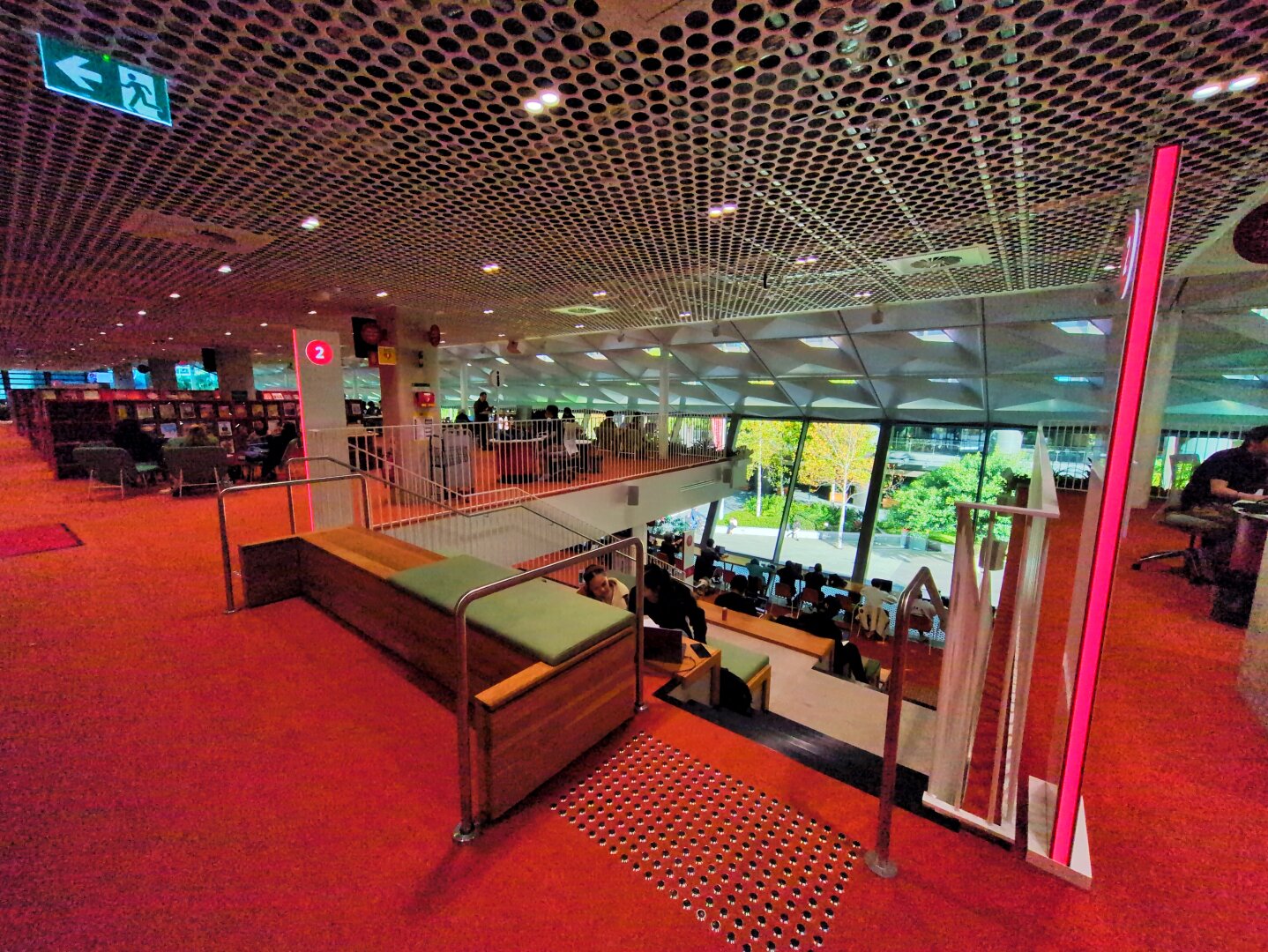 The seating area from the right, showing the top floor of the library. The carpet is very red.