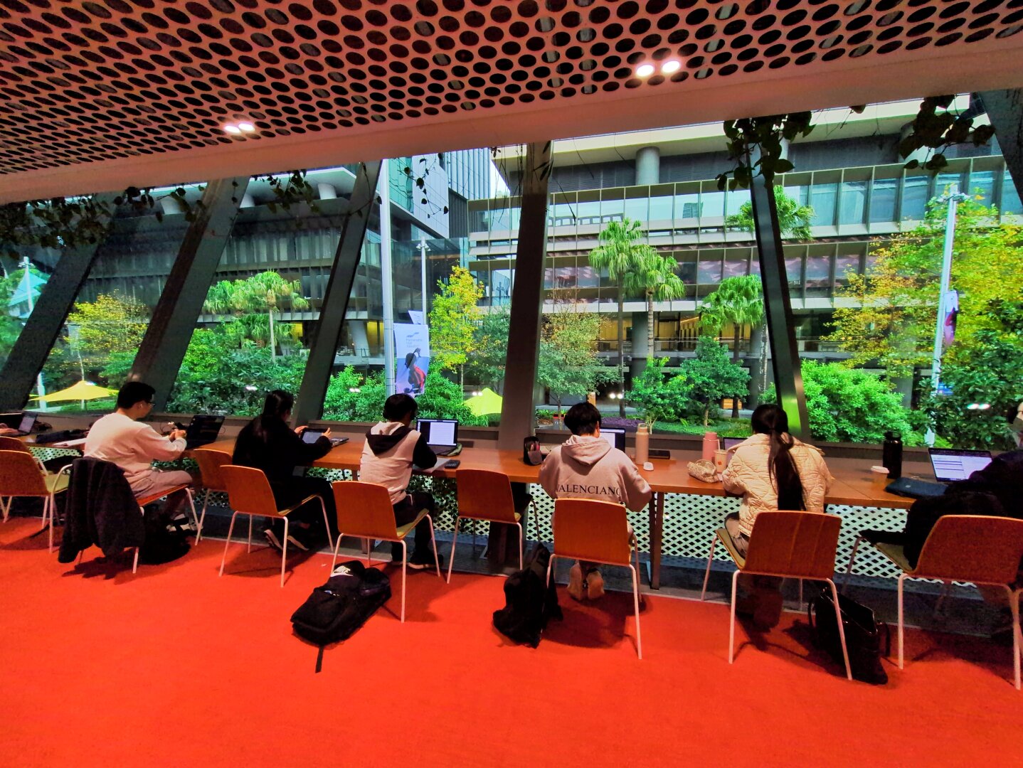 On the lower floor. Desks and chairs face out towards the square.