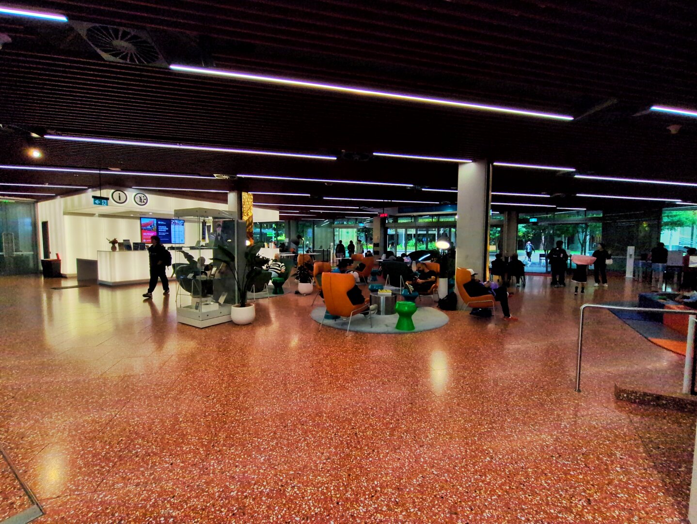 The foyer. An open space with plenty of seating and a white deck in the distance offering council services.