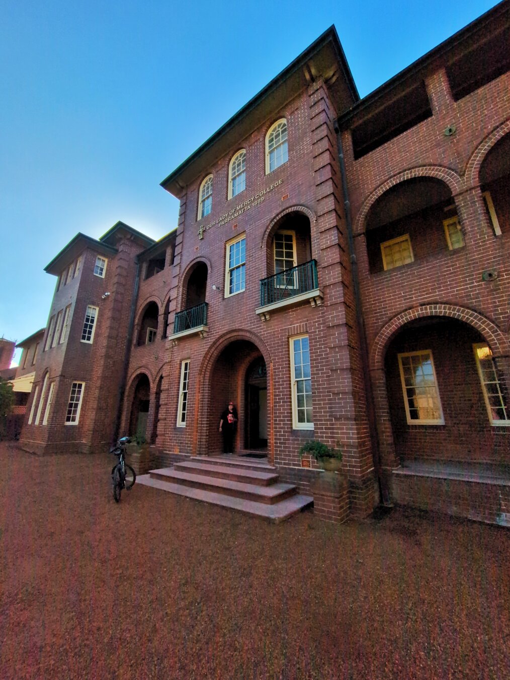 The front entry to Our Lady of Mercy. It's a century-old three-storey brick building with brick arches in front of its balconies.