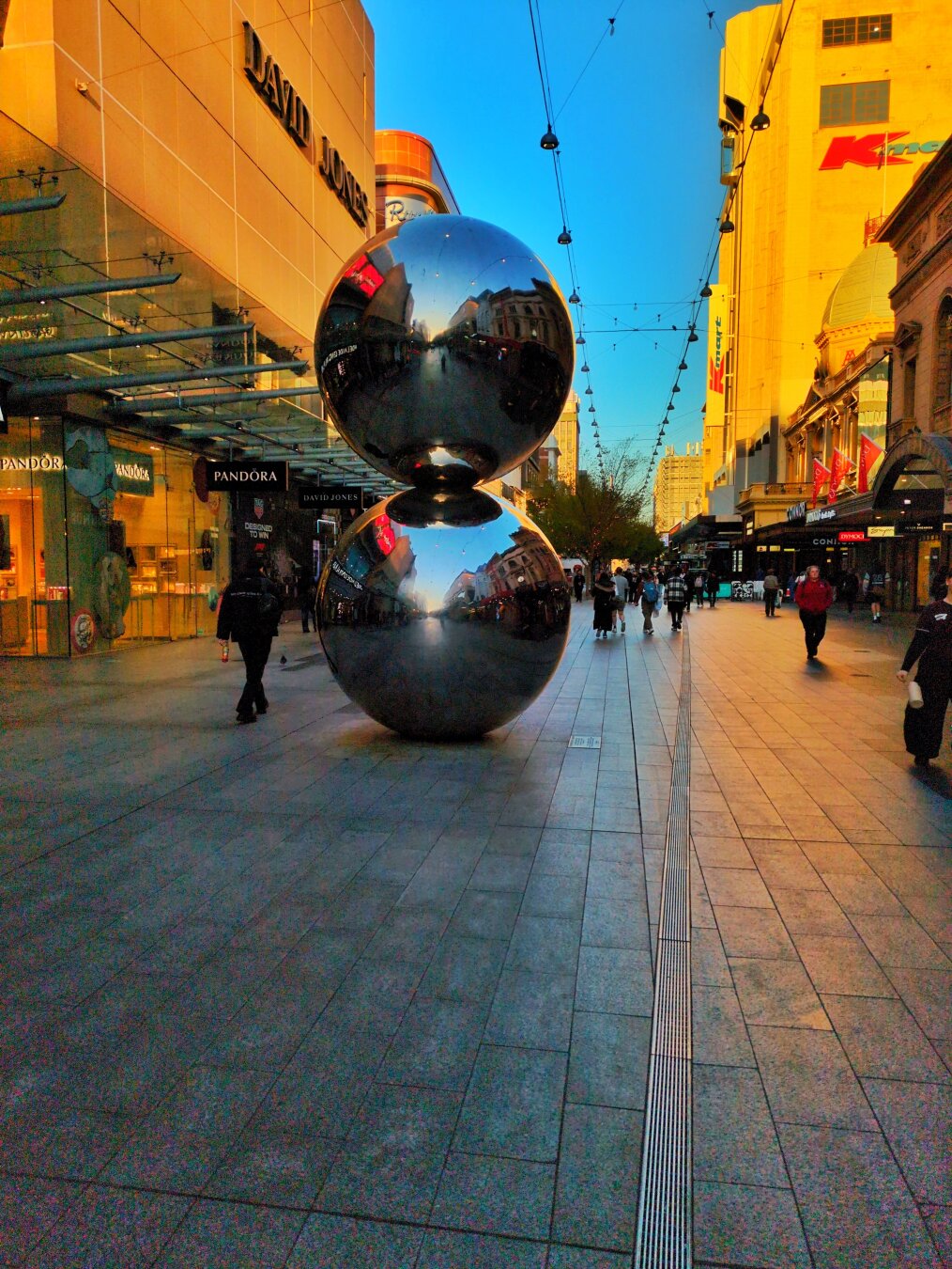 Same public sculpture from a different angle, showing more of the surrounding context.