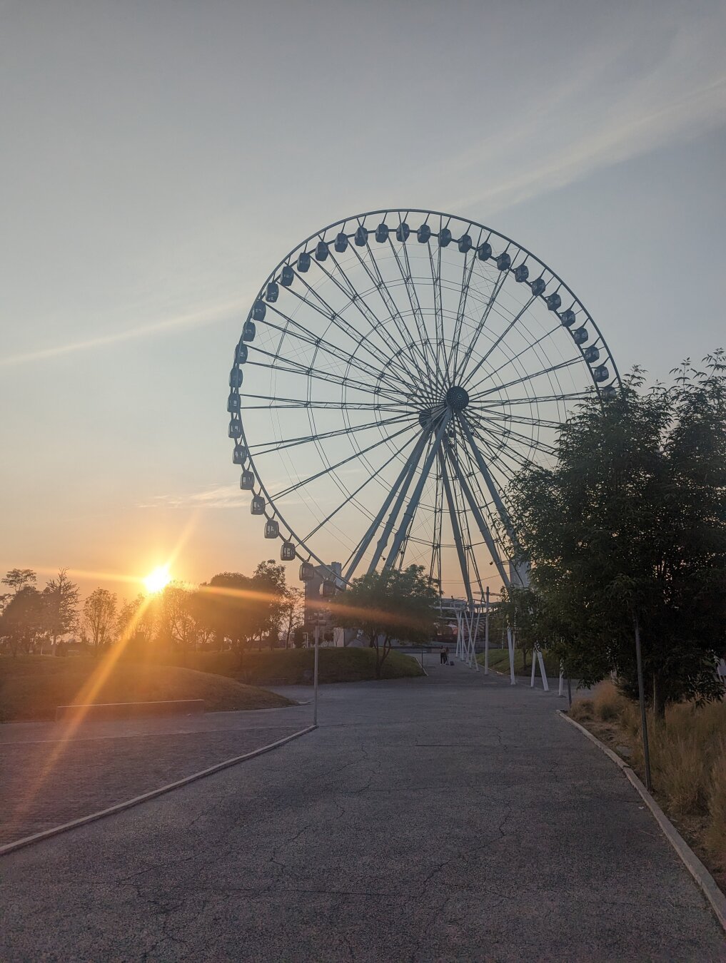 Setting sun next to Estrella de Puebla (a Ferris Wheel)