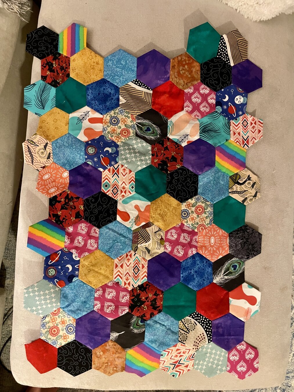 A mostly rectangular arrangement of small, colorful hexagons attached to each other. The grief is currently 7 hexagons horizontally by 14 vertically.